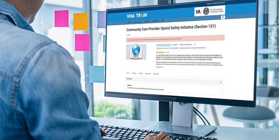Employee on computer with VHA train webpage on the screen.