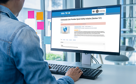 Employee on computer with VHA train webpage on the screen.
