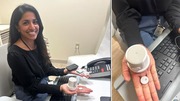 VA clinical pharmacist Lakshmi Singh seated at a desk holding a white cylindrical device and a small round sensor in her open palm.
