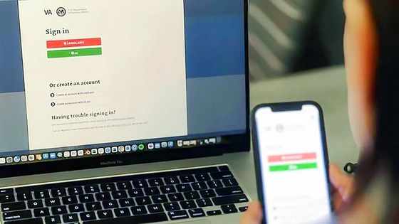 Close-up of a laptop and smartphone displaying the VA sign-in page