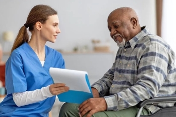 a patient speaks with a nurse in the waiting room