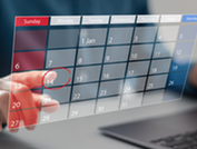 Person clicking a date on a digital calendar.