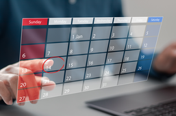 Person clicking a date on a digital calendar.