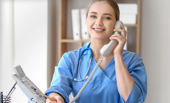 Nurse smiling on the phone.