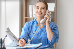 Nurse smiling on the phone.