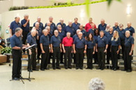a large retired Navy choir singing in large open space