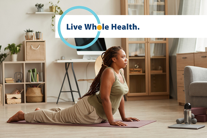 A woman maintains a yoga pose.