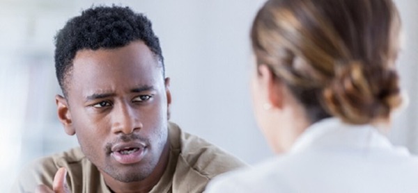 Black male speaking with doctor.