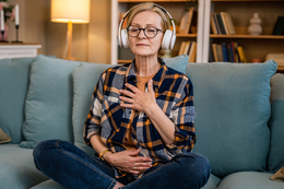 Woman practice guided meditation manifestation at home.