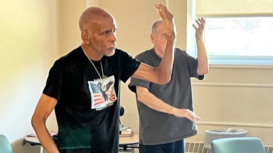 Two elderly men practicing Tai Chi 
