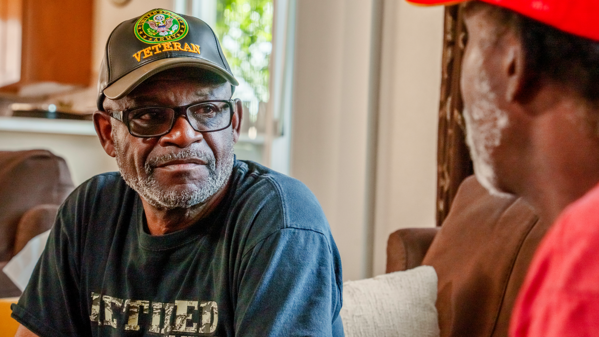 Two older men talking.