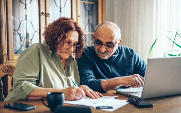 Senior couple using laptop.