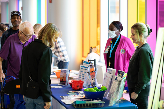 Staff and veterans chat at info tables 