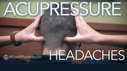 Person applying acupressure to the back of their head to relieve headaches.