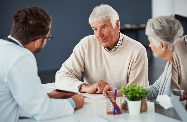 Senior couple meeting with doctor.
