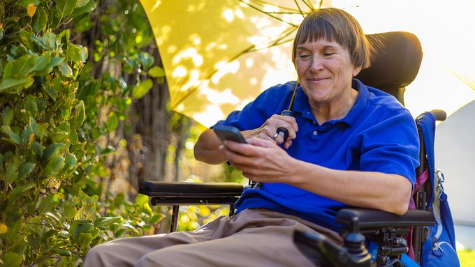 A Veteran checks their phone for appointment updates