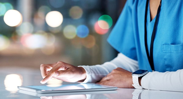 Healthcare, tablet and hands of nurse working online for medical research, planning and schedule in hospital.