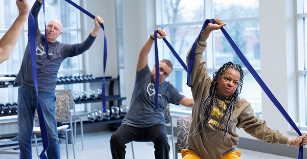 Veterans exercising with exercise bands.