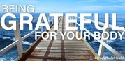 Wooden pier extending into a calm ocean under a clear blue sky with the words 'Being Grateful For Your Body'