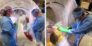 Surgeons in blue scrubs perform a procedure in an operating room.