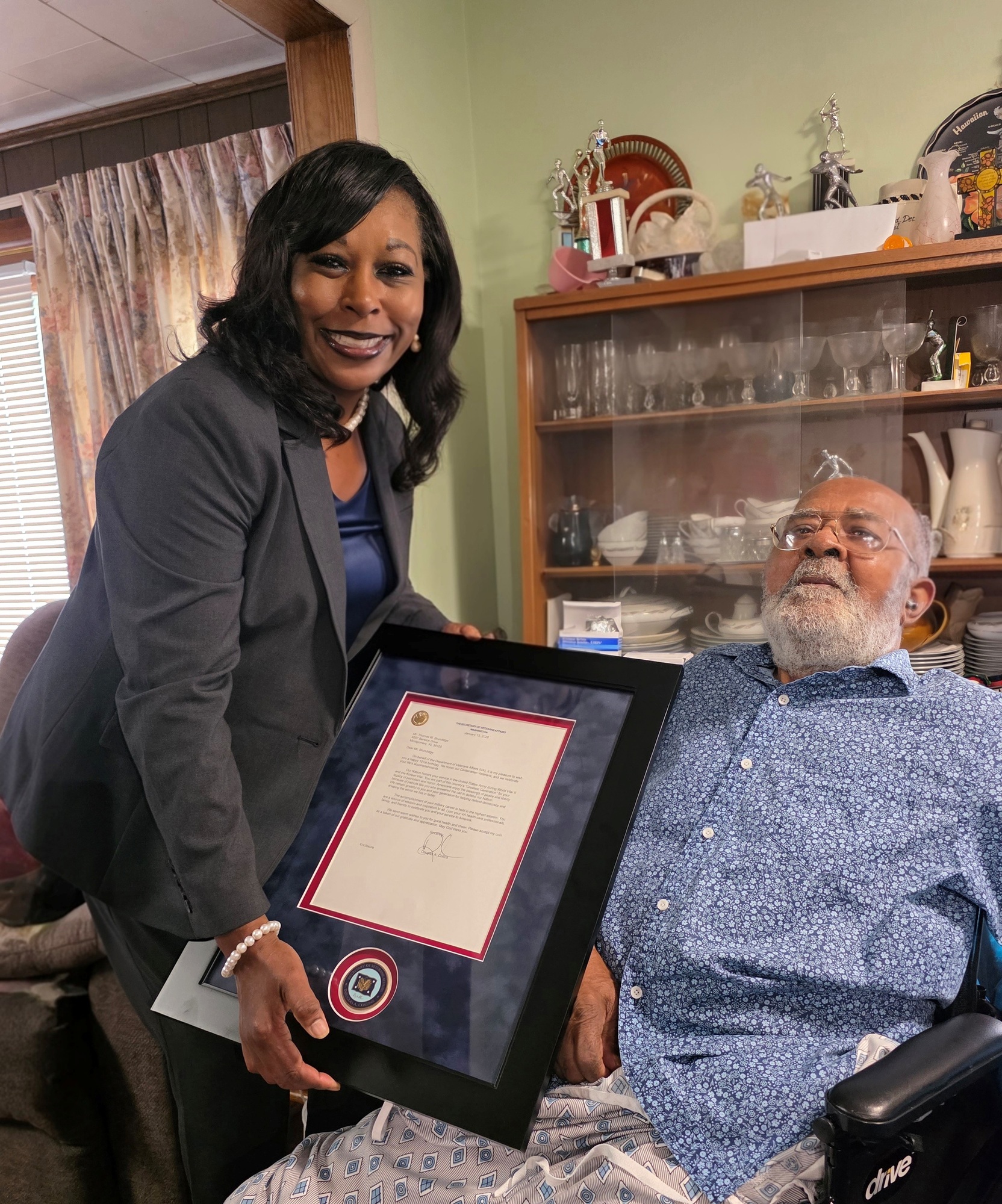 CAVHCS Interim Director and CEO Laundrena LaPradd-Bradley presents Army Veteran Thomas Milton Brundidge with a certificate during his 101st birthday celebration.
