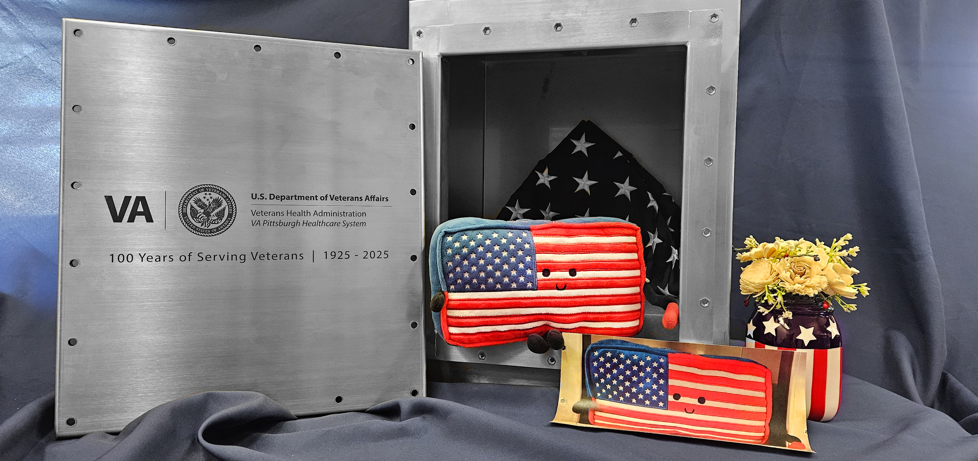 Glory the flag poses with time capsule for H. John Heinz III Department of Veterans Affairs Medical Center 
