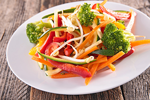 A colorful variety of vegetables on a dinner plate.