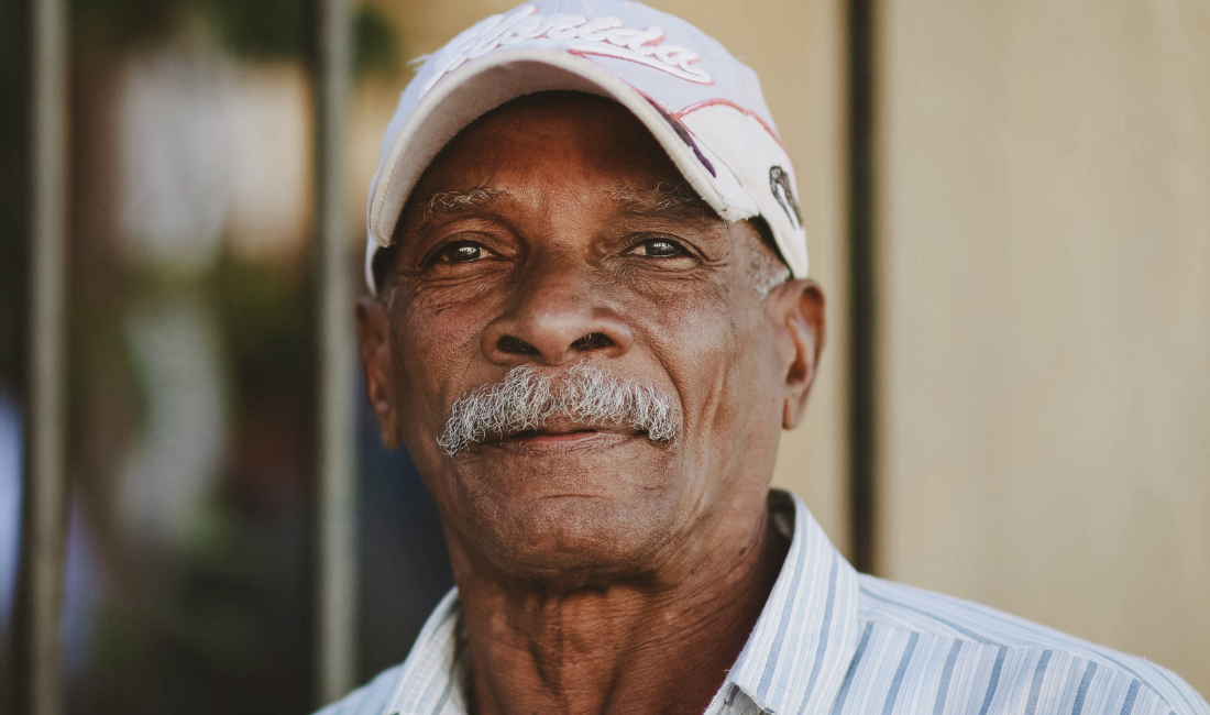 Older man in baseball cap