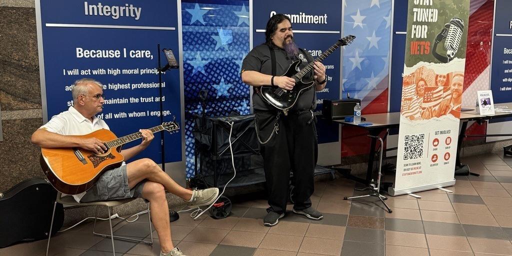 Two Veterans playing guitars