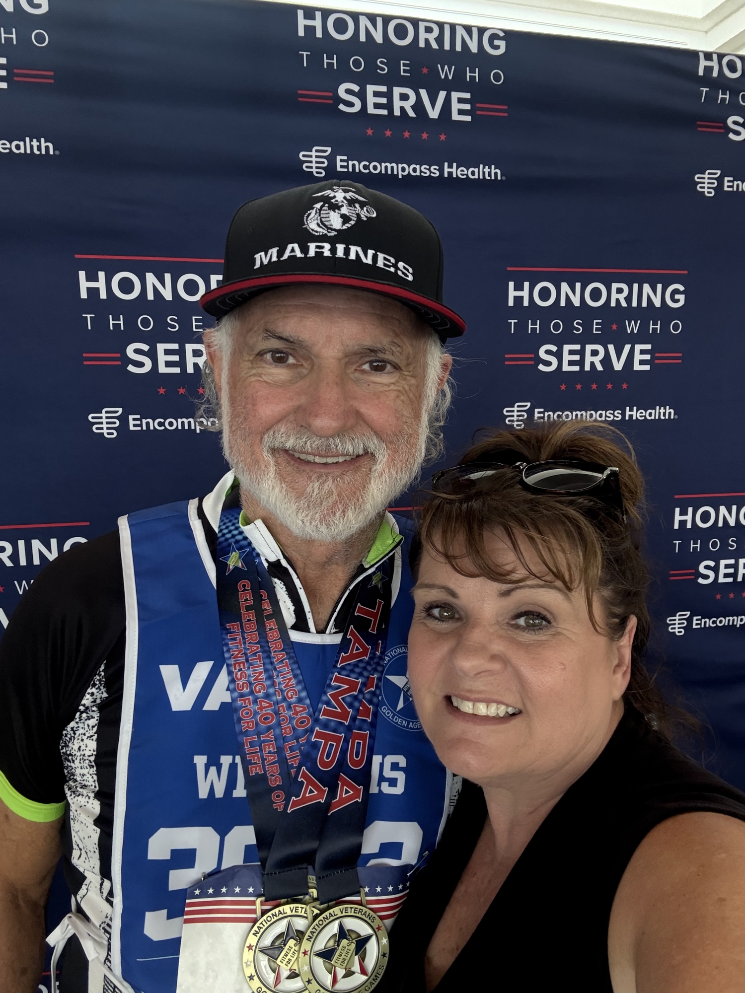 Marine Corps Veteran Aubrey Mick Williams and his wife, Ronda, display the two cycling gold medals he earned.