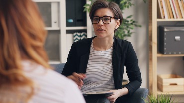 Therapist talking with patient