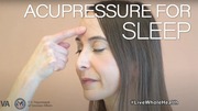 Woman gently pressing her forehead with finger to demonstrate acupressure for better sleep.