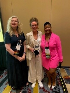 Dr. Colleen Sloan, clinical psychologist, center, receives an Outstanding Contribution award.