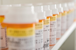 Prescription bottles on a shelf.
