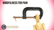 Wooden mannequin figure's head being gently squeezed by a metal clamp symbolizing mindfulness managing pain.