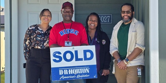 VA staff with Veteran at his new home