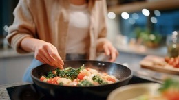 Woman veteran cooking in a skillet.