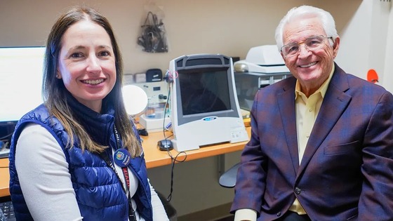 Ed Romero in a picture with a VA audiologist