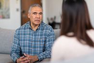 an older man talking to benefits counselor