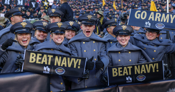 cadets holding go army and beat navy signs