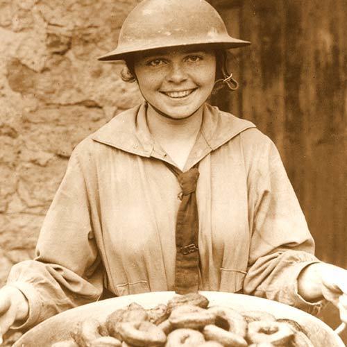 Donut Girl or Lassie in WWI Tin Helmet holding a bowl of confections