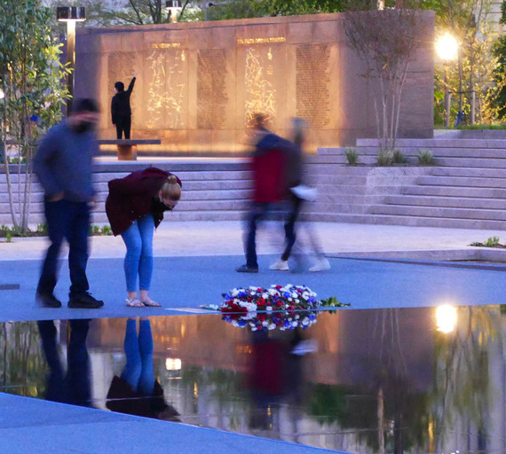 Visitors experiencing the Memorial at dusk