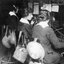 Hello Girls at switchboard with gas masks and helmets square