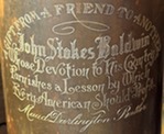 artillery shell casing engraved and mounted on a wooden base, gifted to John Stokes Baldwin