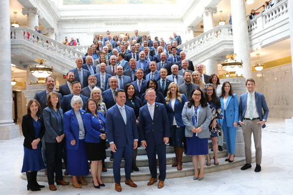 Legislators posing in their blue outfits to show support for water week 