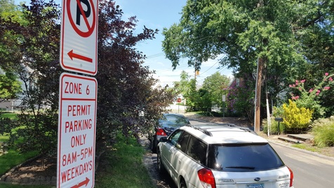car parked with parking sign in forefront
