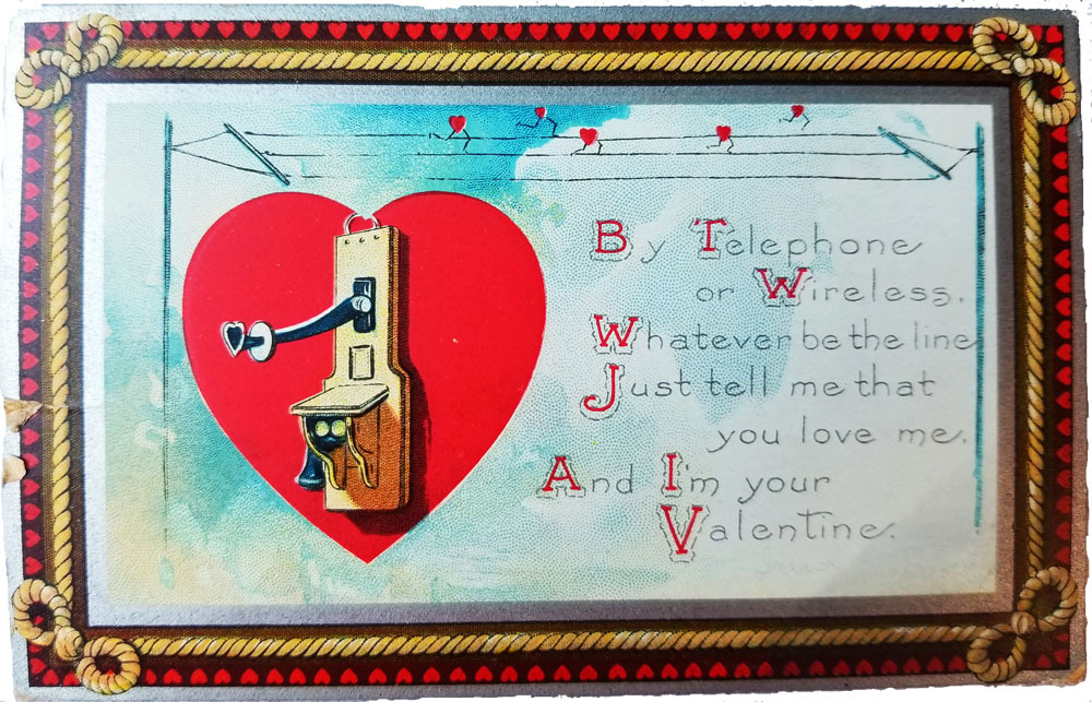 old telephone outlined by a red heart, sitting under telegram wires