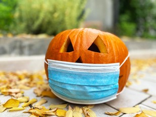 halloween pumpkin wearing a facemask