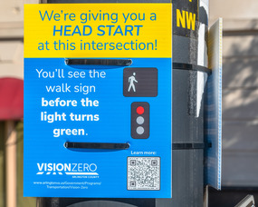 Vision Zero sign that explains what an LPI is (an LPI gives pedestrians a few second head start to cross the street before cars are able to)