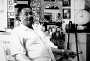 black and white photo of man sitting in a barber shop chair